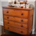 F60. Four-drawer antique dresser with turned wood knobs. 